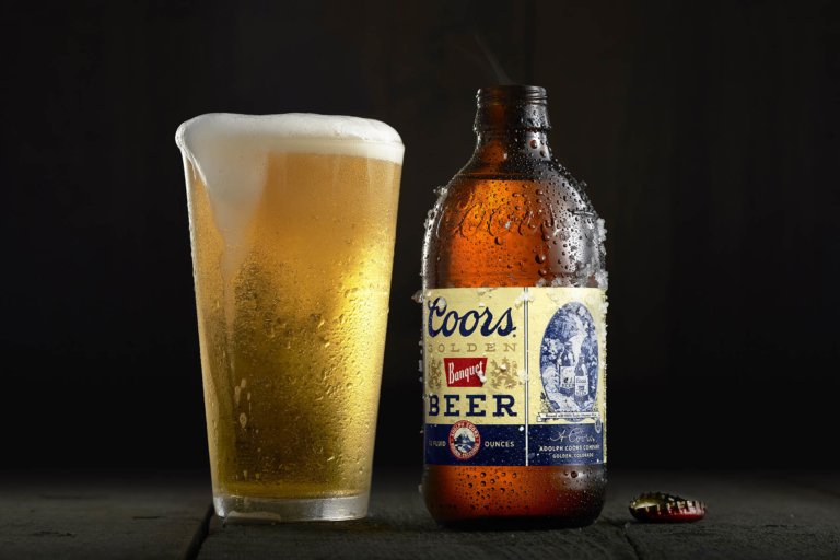 Beer glass and bottle photographed for commercial beverage advertising campaign