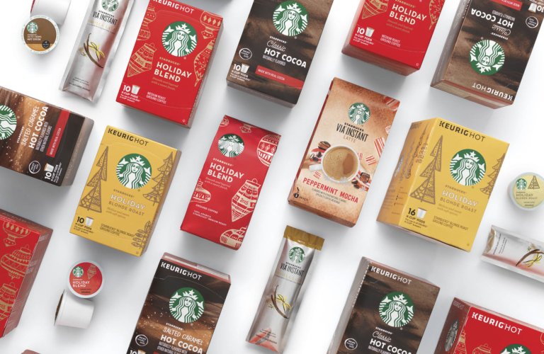 Assorted Starbucks packaged coffees and drink mixes laid out in a geometric flat lay on a white background.