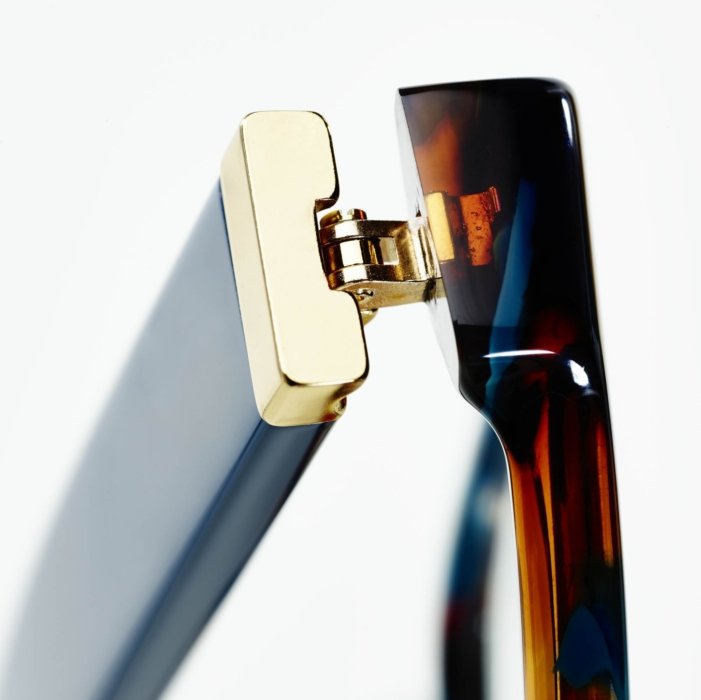 A beauty shot of a hinge on a pair of glasses.