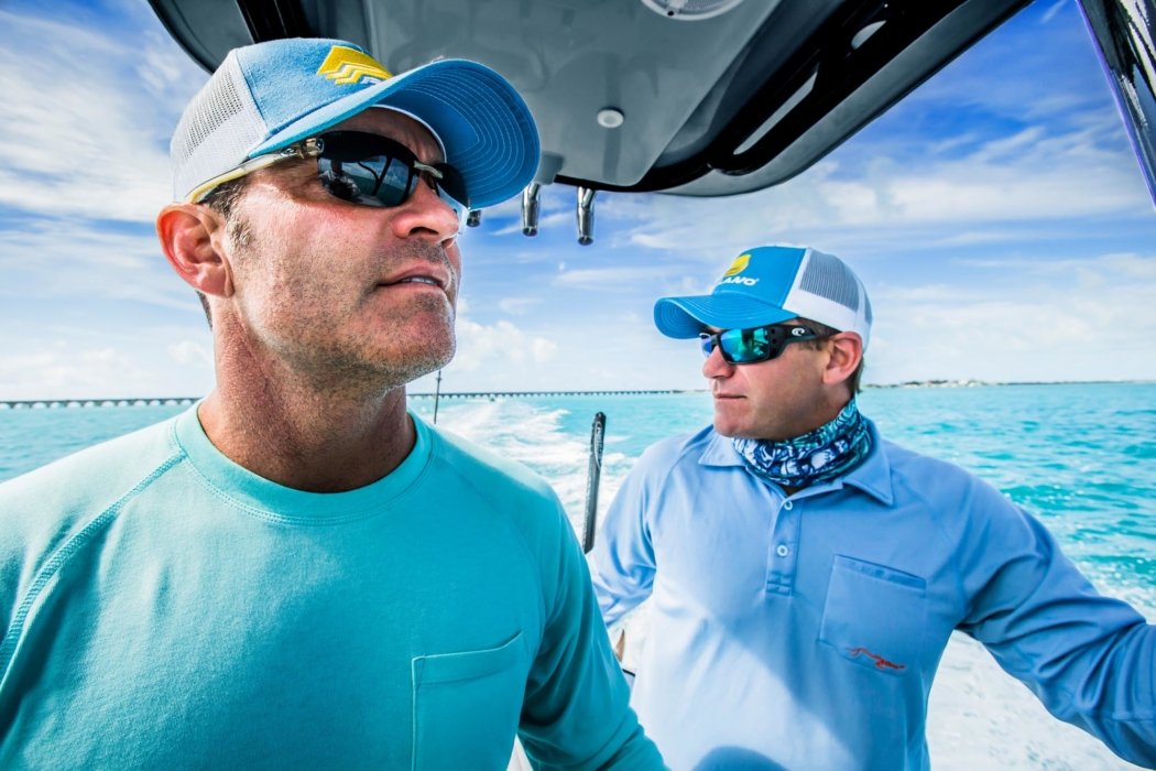 Two men with fishing products on a boat