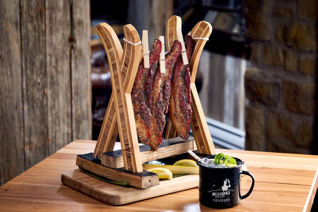 A rack of seasoned bacon hanging