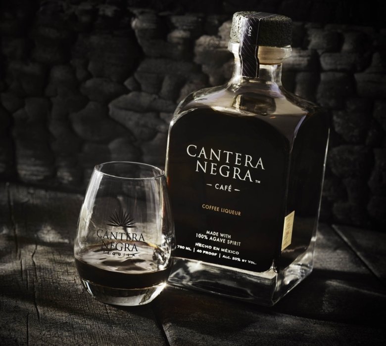 Dark cafe tequila in a charred wood environment - drink photography