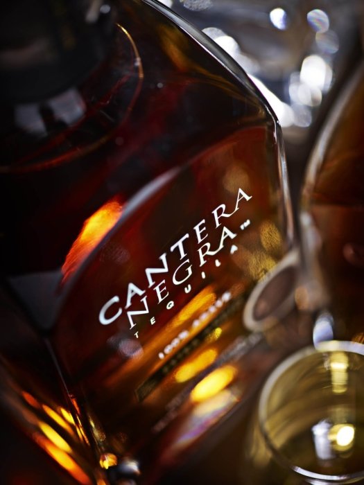 A close top down view of cantera negra tequila bottle - Drink photography