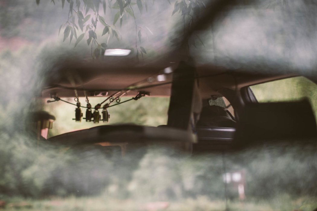 fly rod in the rear view mirror of a car