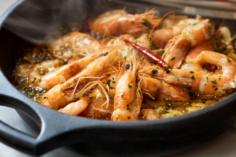 A steamy bowl of whole shrimp and chilies - food photography
