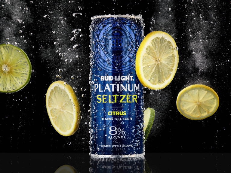 Blue seltzer can surrounded by powder explosion captured in commercial beverage photography