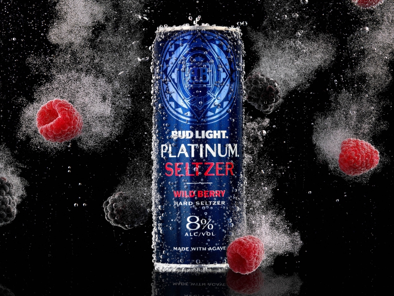 Bud Light Platinum Seltzer can surrounded by dramatic powder splash and raspberries in commercial beverage photography