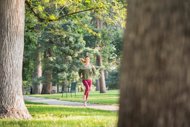 A young woman running on a campus - Denver lifestyle photography