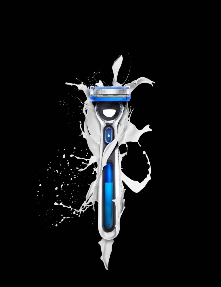 Product surrounded by white liquid splash captured using high-speed commercial photography techniques