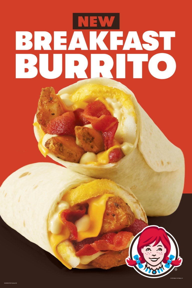 Close-up of a breakfast burrito cut in half, showing eggs, cheese, peppers, and crispy chicken inside, with branded “Breakfast Burrito” text above.