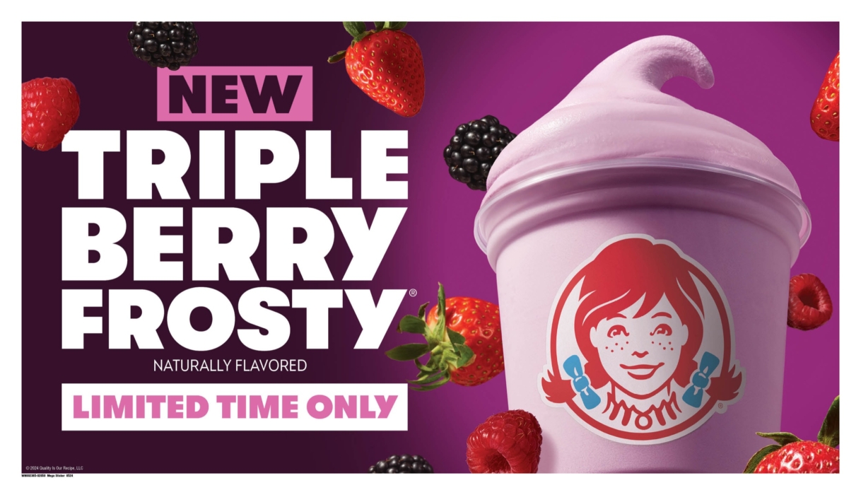 a pink drink with strawberries and berries