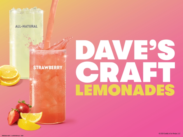 Wendy's Dave's Craft Lemonade strawberry variety in tall clear cups on a pink and orange gradient background with fresh strawberries and lemons