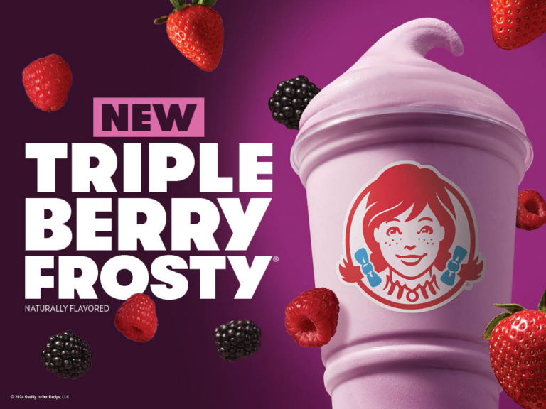 Pink Triple Berry Frosty with floating strawberries, blackberries, and raspberries against a purple background, photographed by OMS Photo.