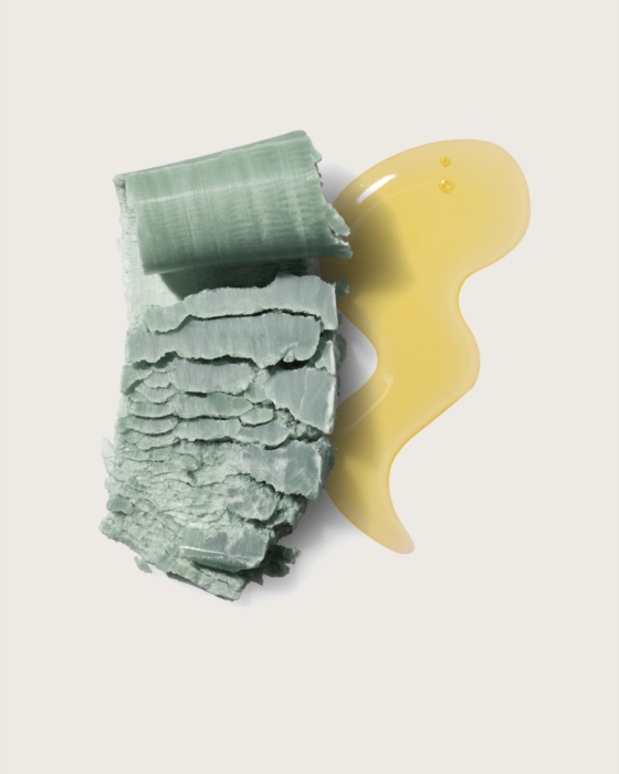 a green piece of food with a yellow liquid
