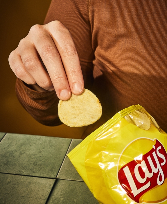 a person holding a potato chip