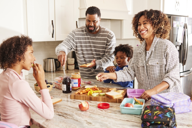 diverse family cooking together in bright kitchen lifestyle commercial photography for food brand campaign