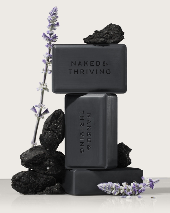 a stack of black soaps with lavender flowers