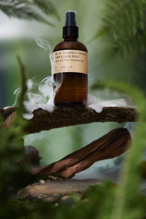 a glass bottle with smoke on a branch