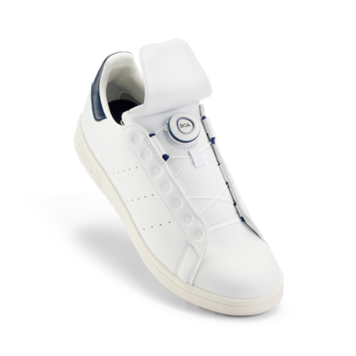 a white shoe with a button on the bottom