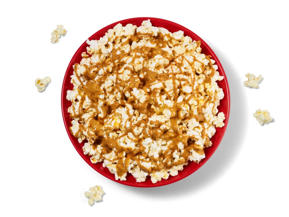 a bowl of popcorn with caramel sauce
