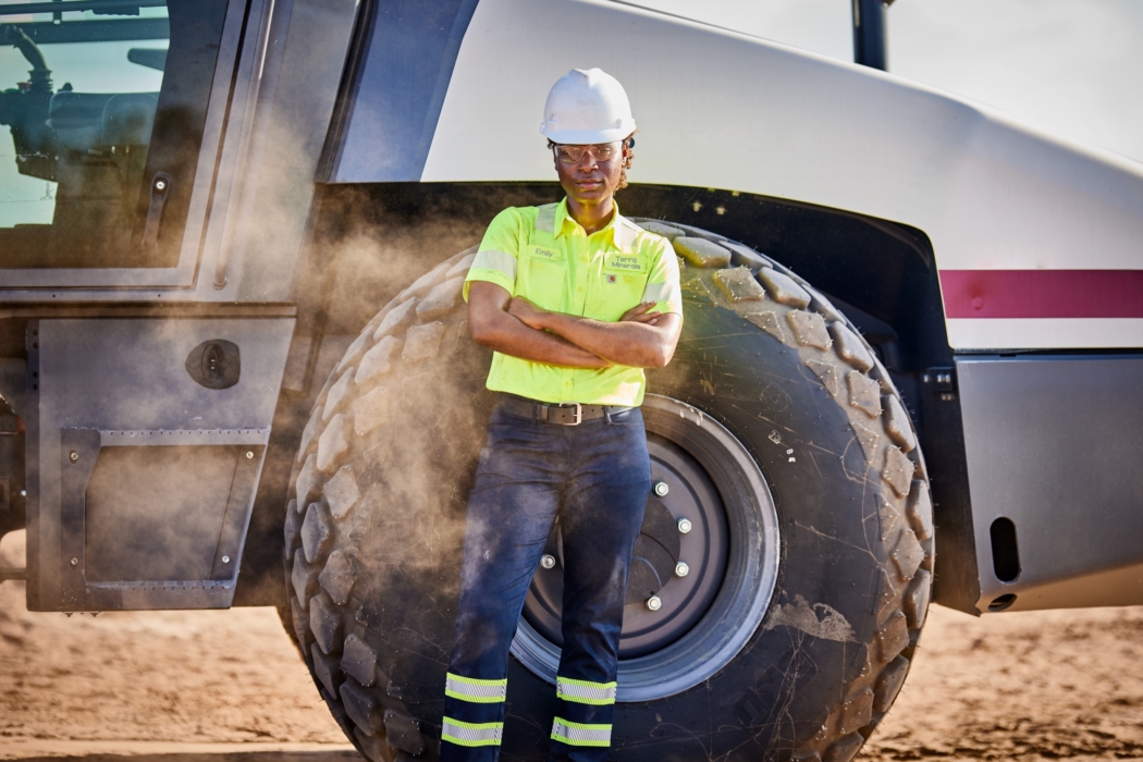 a woman standing in front of a large truck, Cintas, construction, workplace, jobsite, on location