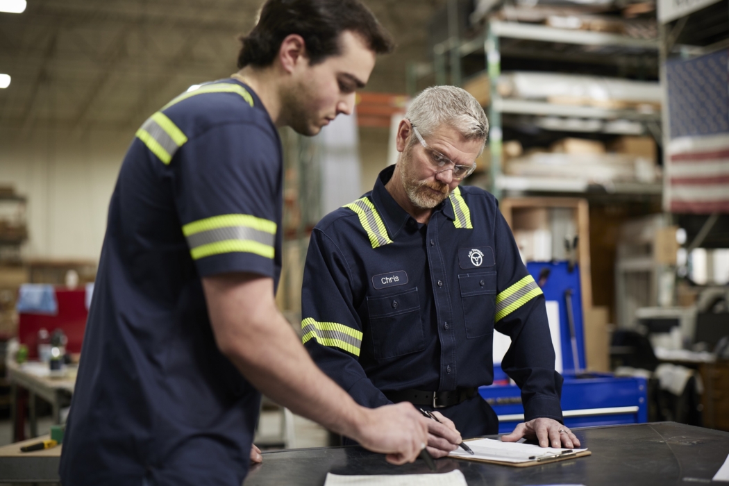 a man writing on a clipboard, Cintas, construction, workplace, jobsite, on location