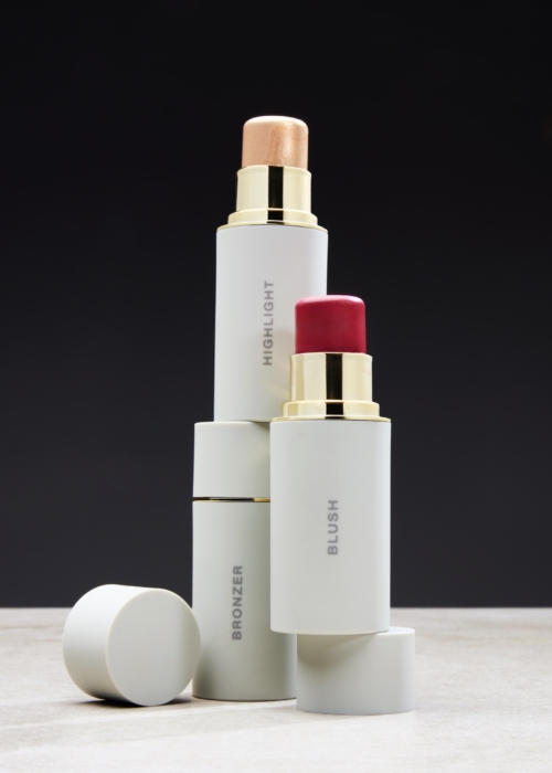 Group of white-packaged lipsticks styled and photographed by beauty and cosmetics commercial photographer at OMS Photography