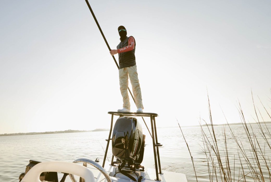 Man fishing on a boat in open water, captured for outdoor adventure and angling lifestyle photography by OMS Photography