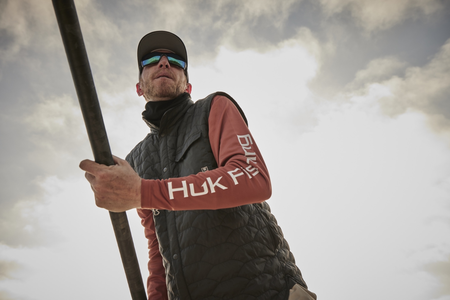 Man fishing from a skiff in open water, outdoor and angling lifestyle photography by Monty Milburn