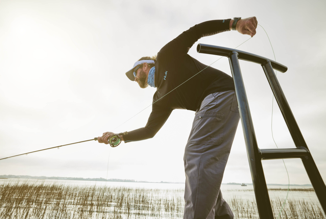 Man fishing on a boat in open water, captured for outdoor adventure and angling lifestyle photography by OMS Photography
