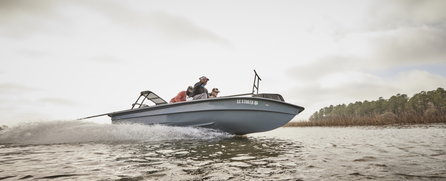 Anglers in HUK performance apparel actively fishing on river or lake, photographed for outdoor lifestyle and gear marketing by OMS Photography