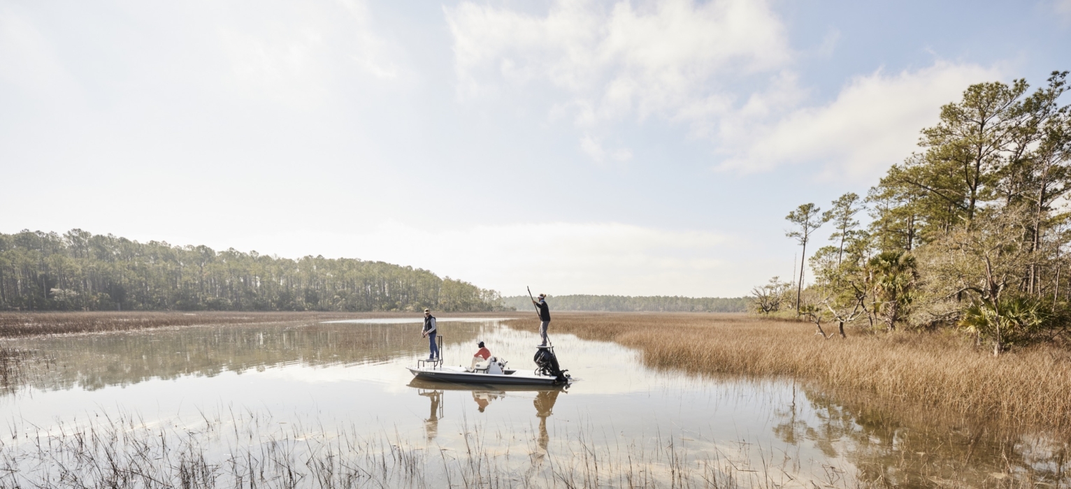 Anglers in HUK performance apparel actively fishing on river or lake, photographed for outdoor lifestyle and gear marketing by OMS Photography