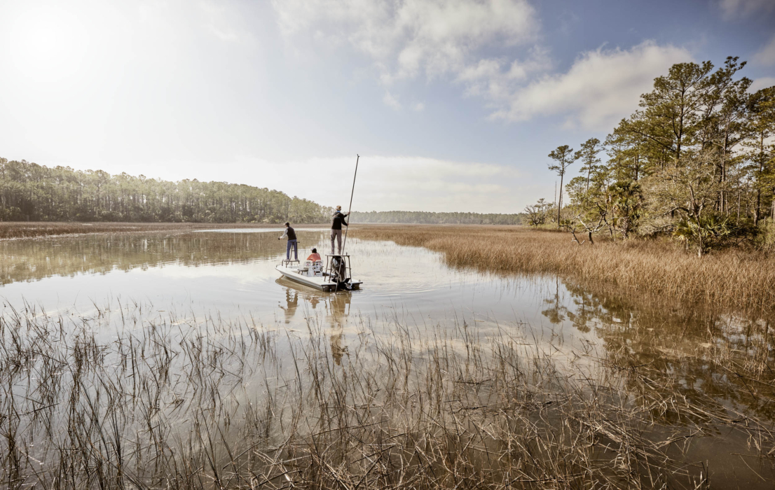 Anglers in HUK performance apparel actively fishing on river or lake, photographed for outdoor lifestyle and gear marketing by OMS Photography