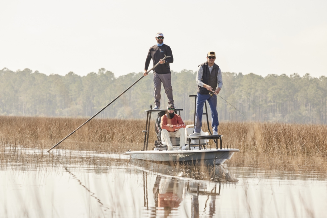 Anglers in HUK performance apparel actively fishing on river or lake, photographed for outdoor lifestyle and gear marketing by OMS Photography