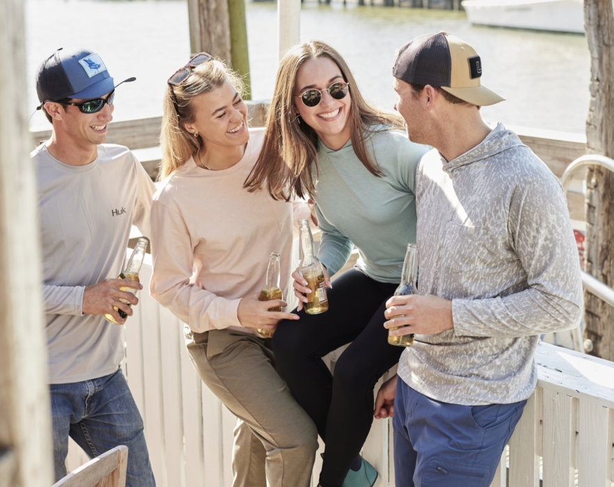 Group of people in outdoor apparel gathered in natural setting, captured for adventure lifestyle and brand photography by OMS Photography