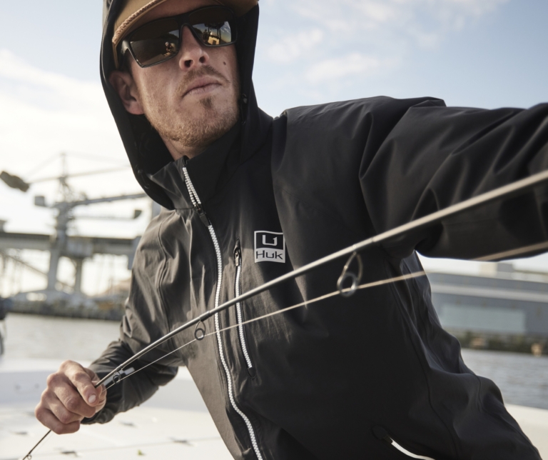 Angler casting a line at sunrise on the water, on-location outdoor lifestyle and adventure product photography by OMS Photography