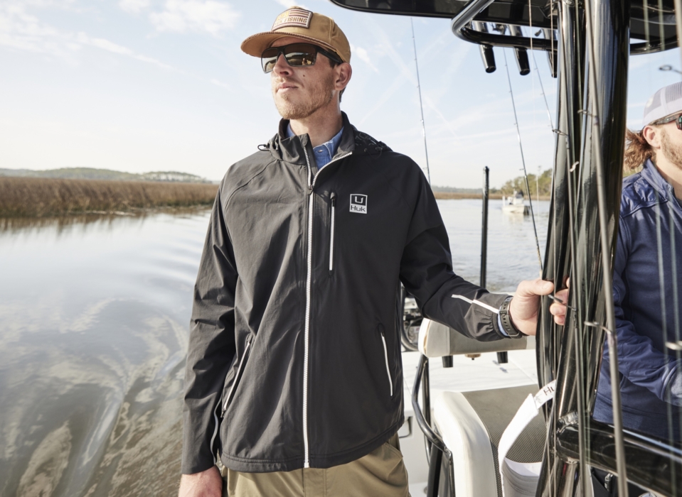Anglers in HUK performance apparel actively fishing on river or lake, photographed for outdoor lifestyle and gear marketing by OMS Photography