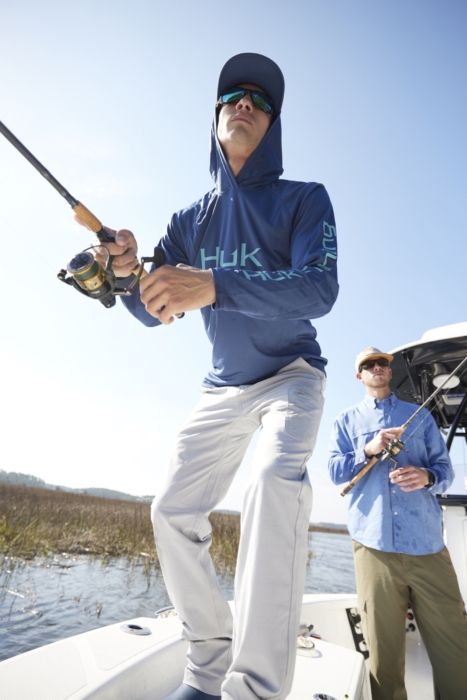Close-up of two men fishing together in outdoor setting, captured for adventure lifestyle and angling brand photography by OMS Photography