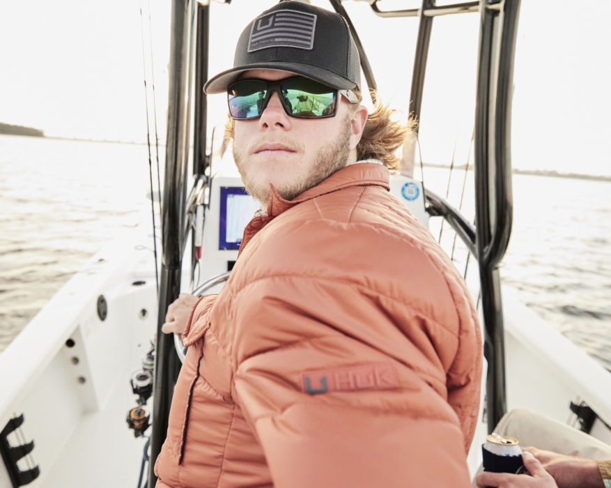 Man on fishing boat wearing HUK performance gear, captured for outdoor adventure and lifestyle brand photography by OMS Photography