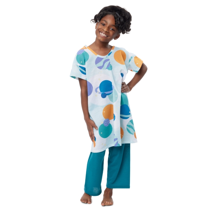 Children wearing colorful pediatric hospital gowns photographed on a white background by Marci Rhodes of OMS Photography – clean textile image showcasing fit, pattern, and comfo