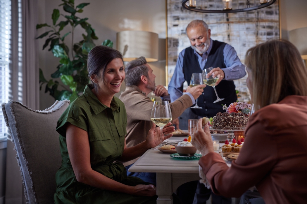 a group of people sitting at a table with wine glasses