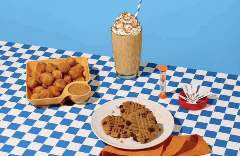 a plate of cookies and a drink on a checkered table