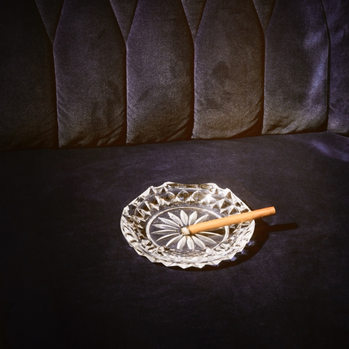 a glass ashtray with a cigar on it
