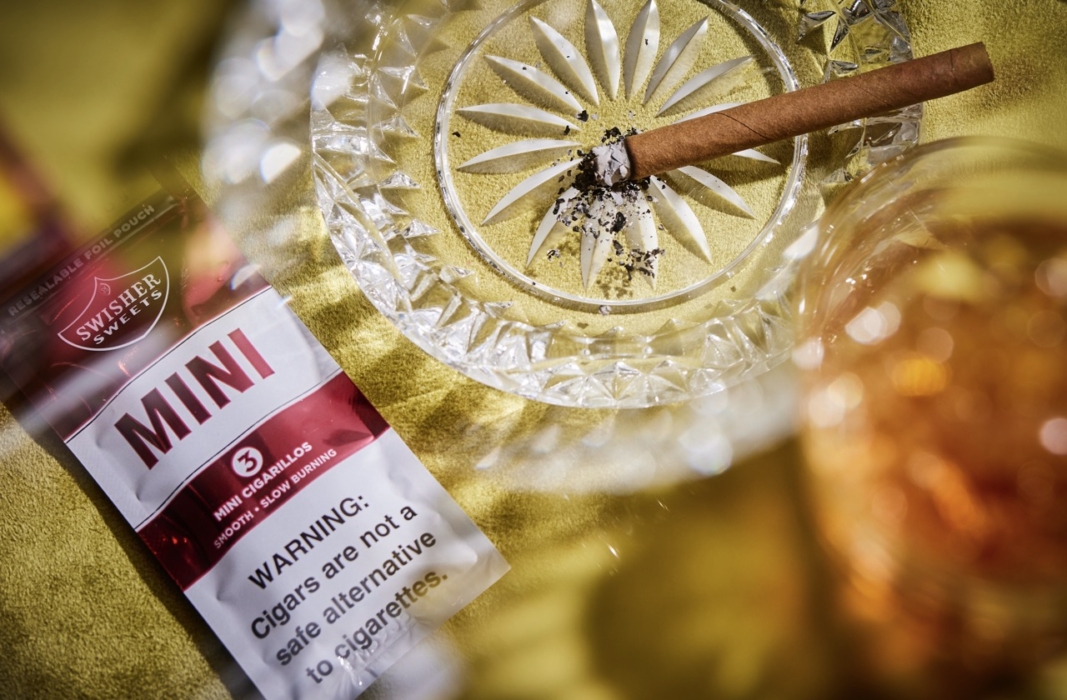 a cigarette in a glass ashtray