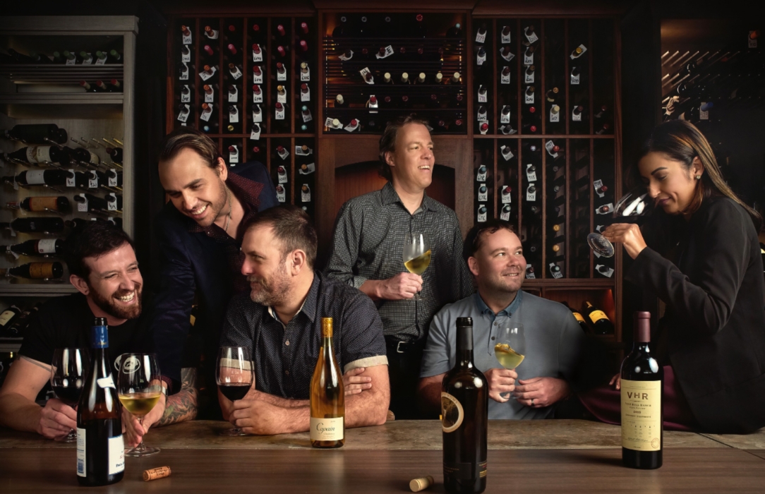 Group of people drinking wine in a wine cellar-style restaurant, captured for lifestyle, restaurant, and food photography by OMS Photography