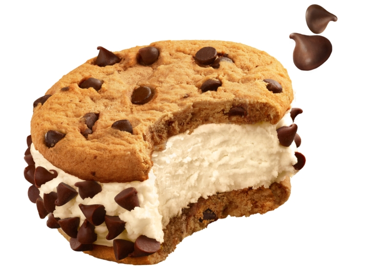 Chocolate chip cookie ice cream sandwich with a bite taken out, isolated on a white background.