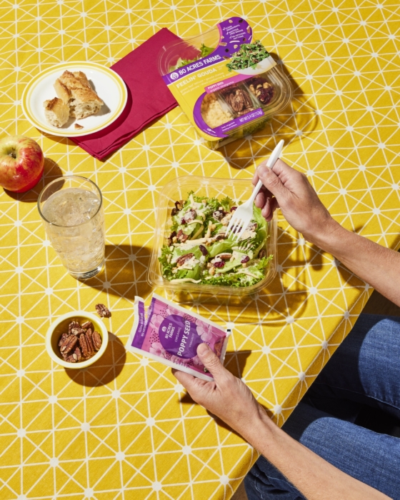 Lifestyle, salad kit, 80 acres, food, person, table, nuts, apple, bread, salad, dressing, yellow