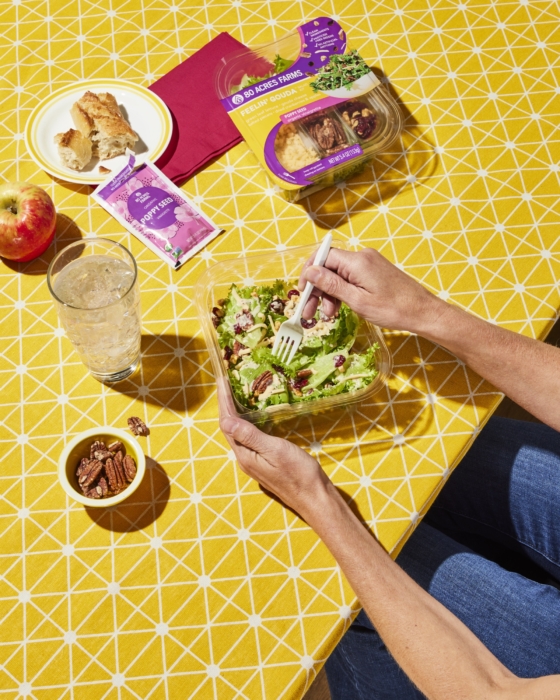Lifestyle, salad kit, 80 acres, food, person, table, nuts, apple, bread, salad, dressing, yellow