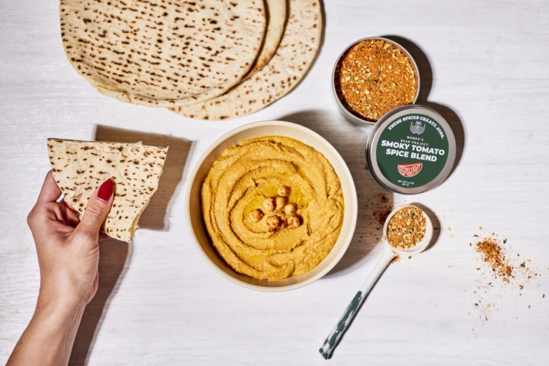Hummus spread with flatbread and ingredients — commercial food photography by OMS Photo