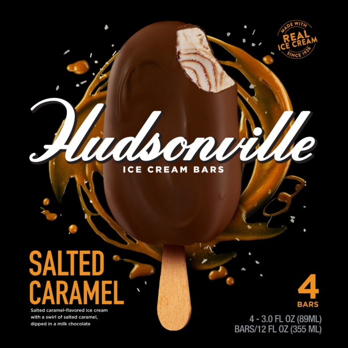 Commercial food photography of salted caramel ice cream bar dipped in chocolate with caramel splash on black background, frozen dessert packaging image